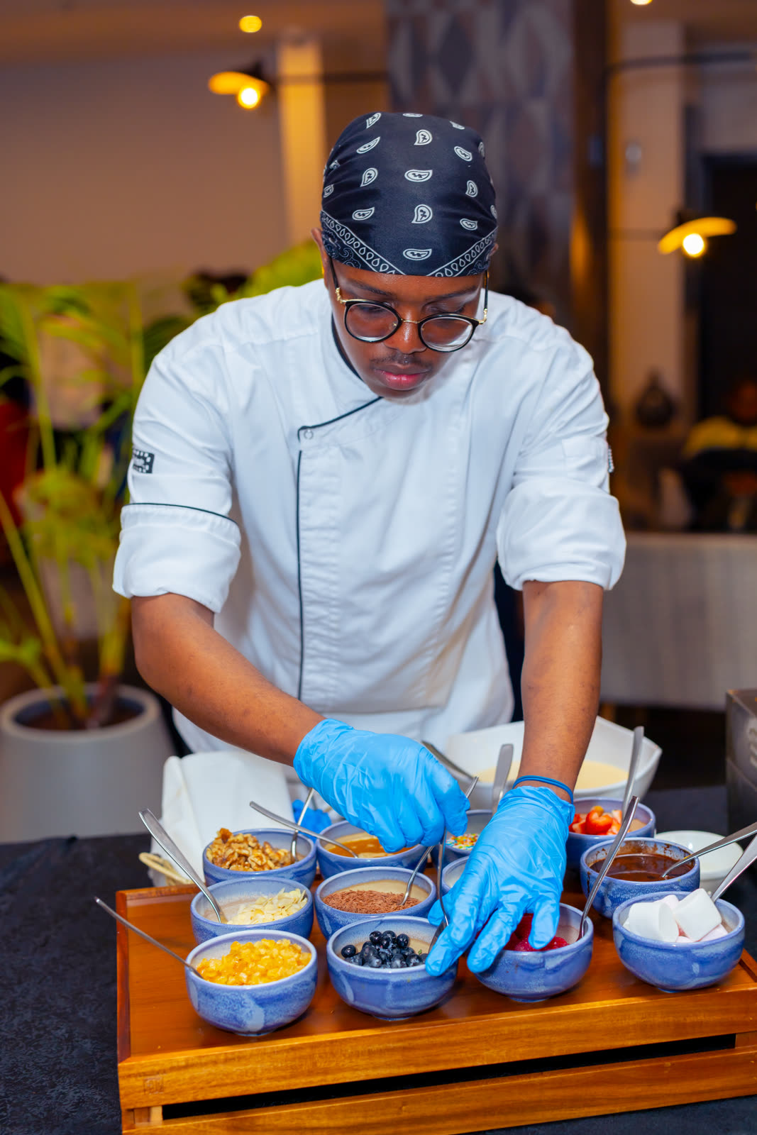 Chef plating dessert toppings at a live activation